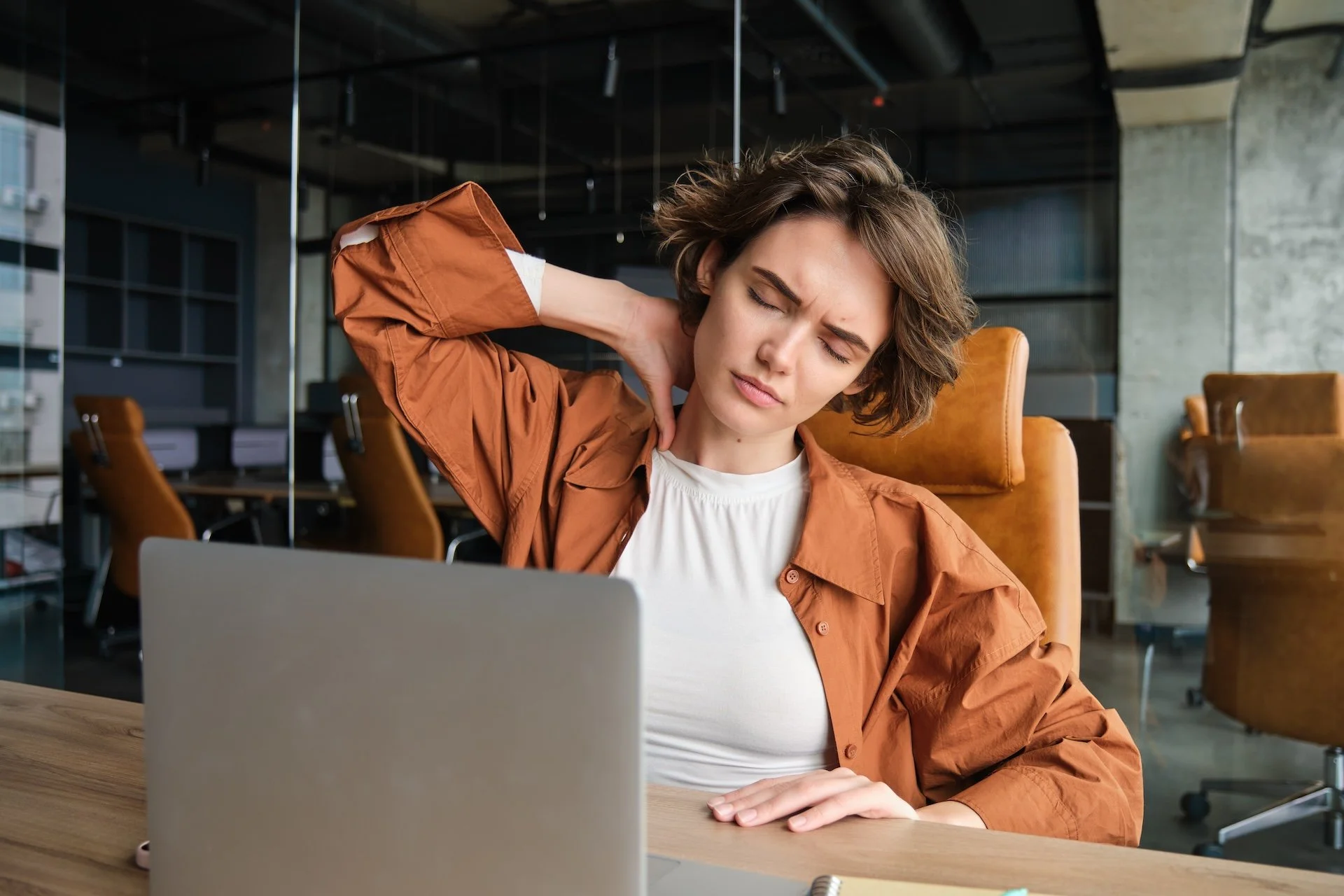 Person holding neck and shoulder tension caused by stress and daily pressure
