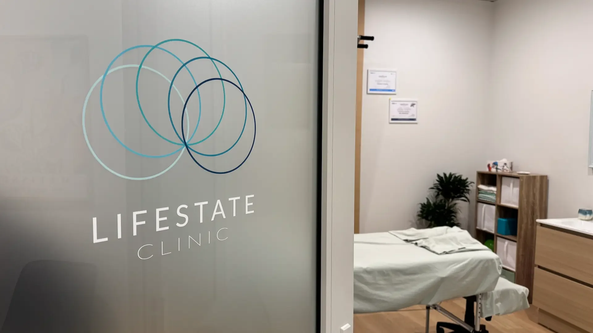 Calm treatment room with a massage table in warm natural light