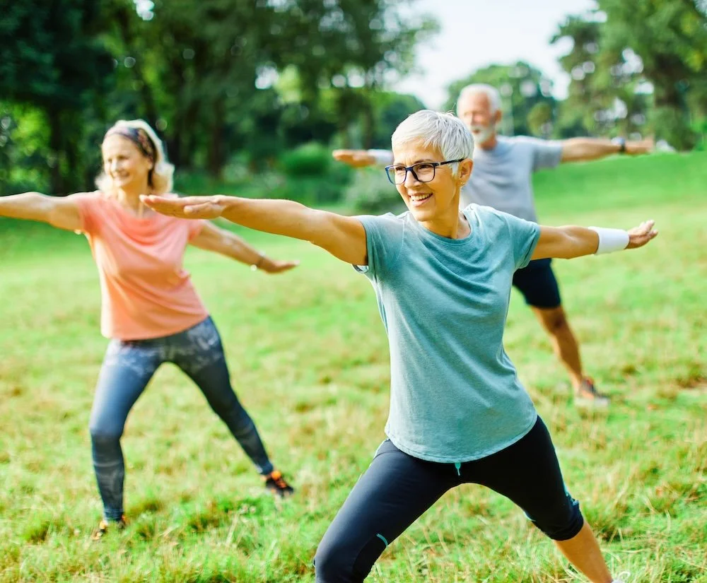 Older adults moving outdoors, representing mobility, strength and gradual return to movement after surgery.