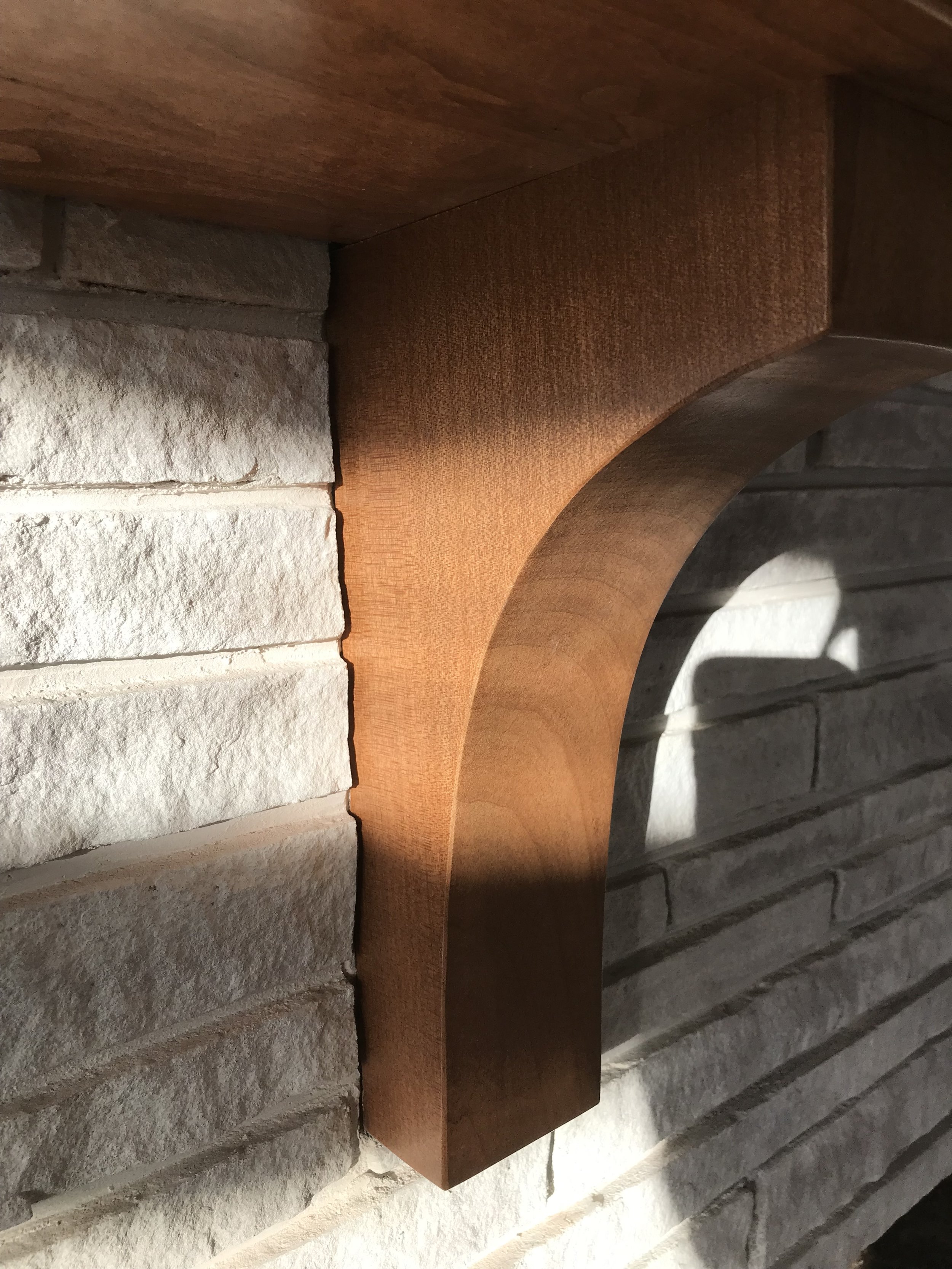 Close-up view of a stone and brick wall with a wooden arch.