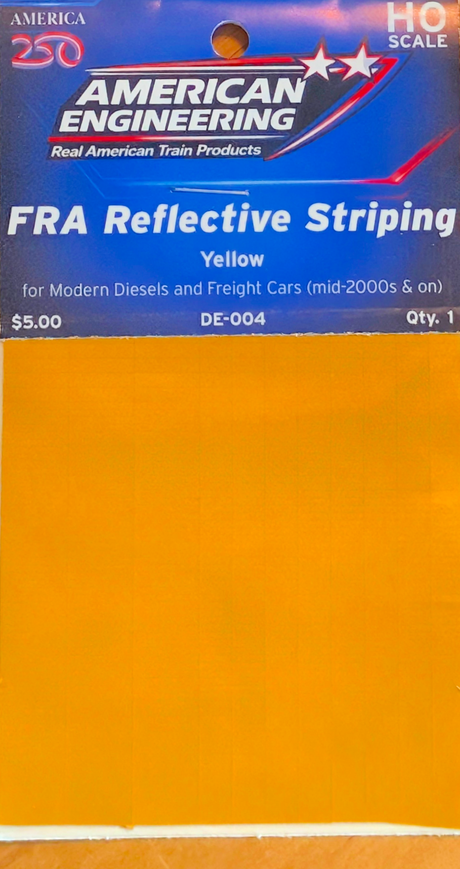 Package of American Engineering FRA Reflective Stripping in yellow color for model train products, priced at $5.00, with a QR code and product information on the blue and yellow packaging.