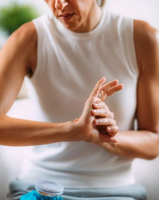 Physiotherapist assessing a patient’s wrist and hand movement