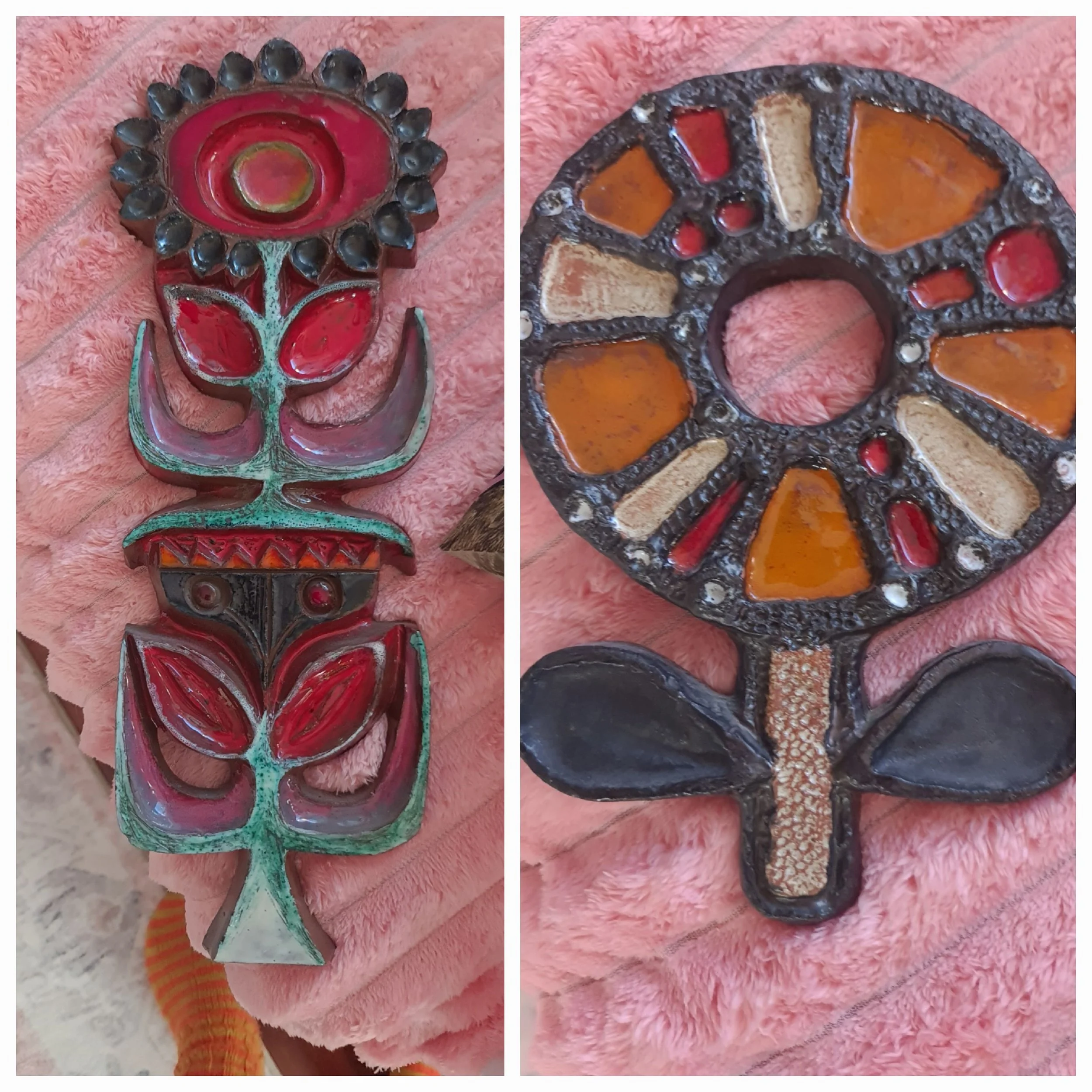 Colorful painted wooden totem or mask with floral and geometric patterns, placed on a soft pink textured blanket.
