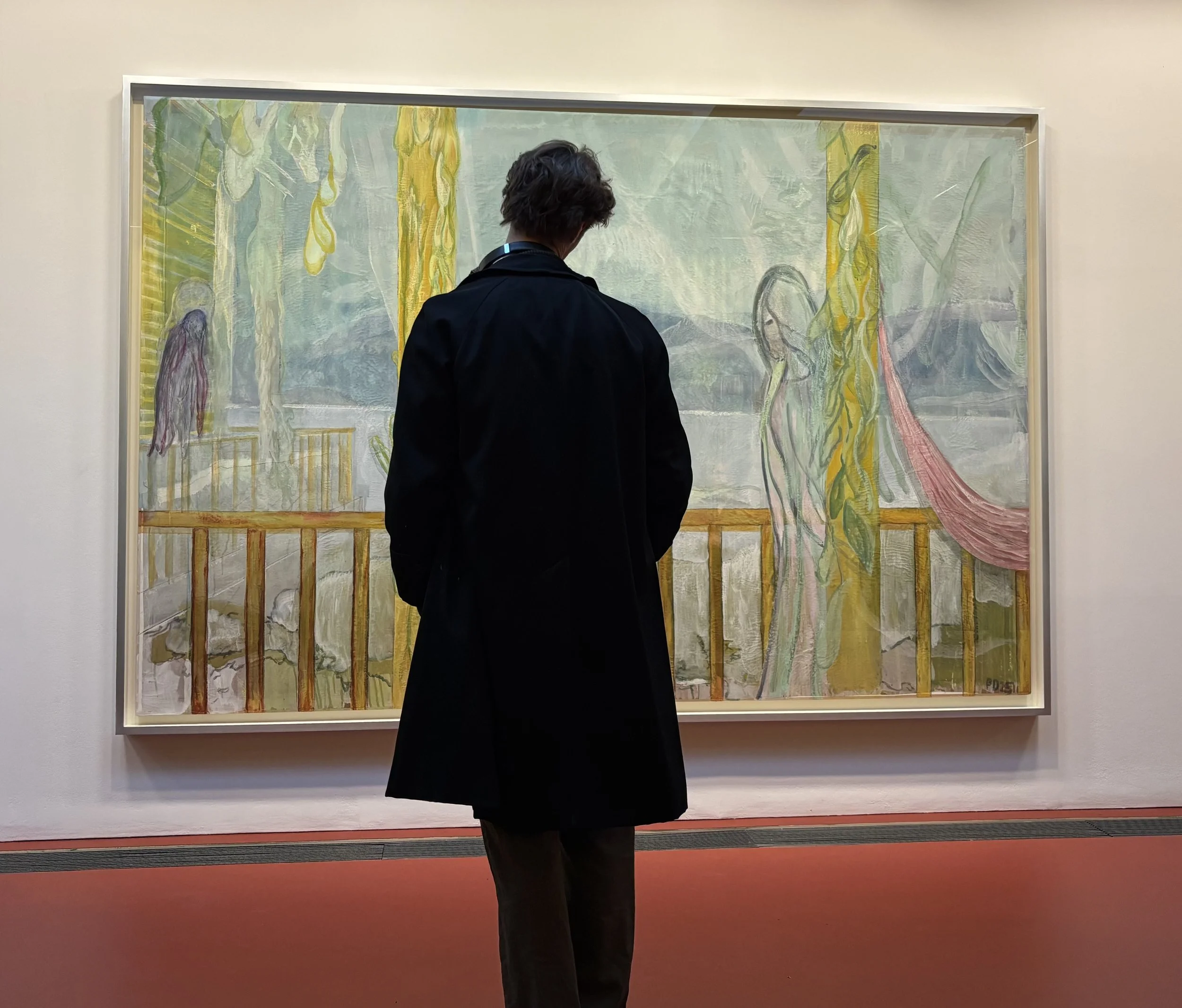 Person in a black coat viewing a large framed Peter doig figurative painting in the serpentine gallery london