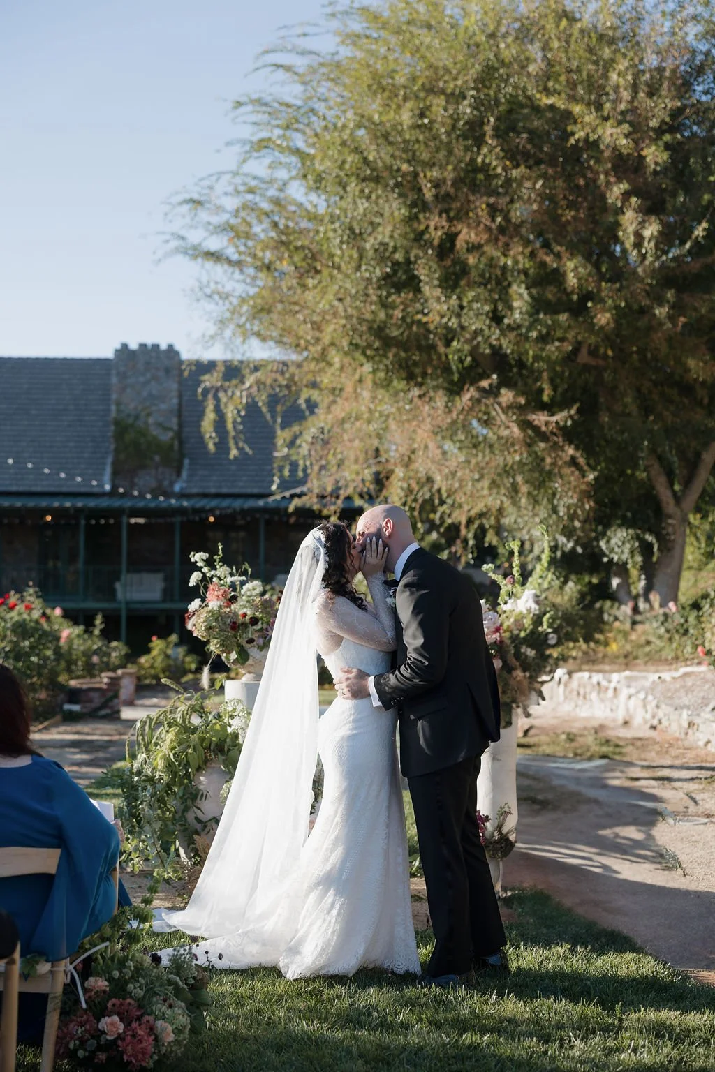 a bride and groom exchanging their first kiss during wedding ceremony at Jasper and lane Events wedding