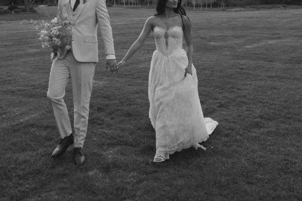 a Jasper and Lane Events  bride and groom holding hands as they walk the grounds of stonepine estate in carmel valley