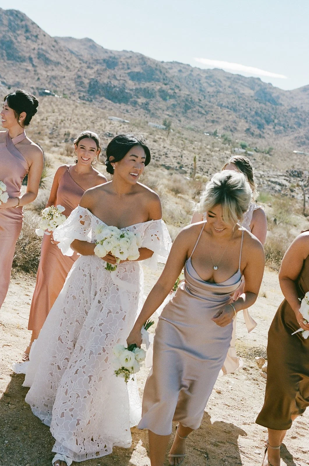 Bride with bridal party walking in joshua tree desert for wedding