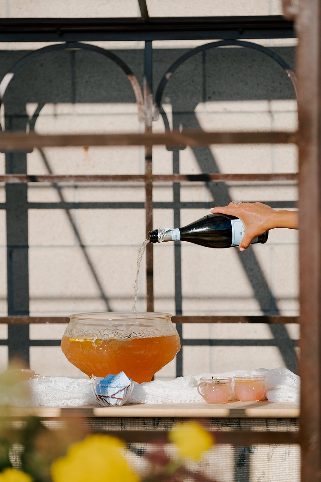 champagne being poured into a punch bowl at a wedding designed by Jasper and Lane Events