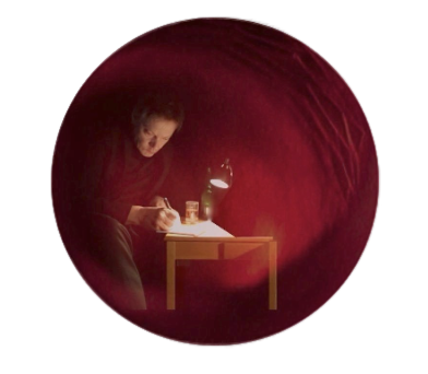 William Orbit sitting at a table with a candle and drinks, viewed through a round red fabric or tunnel.