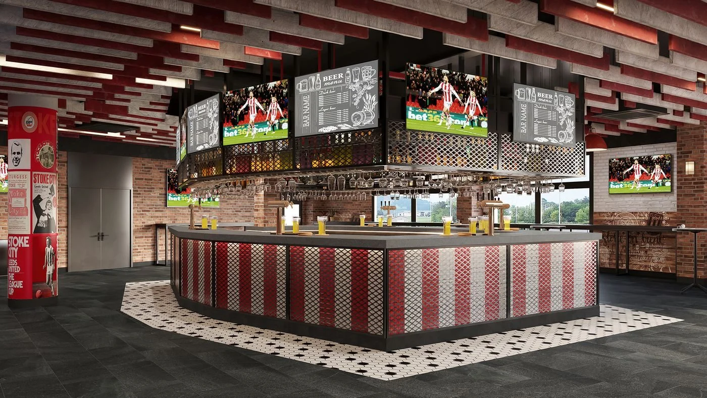 An indoor sports bar with multiple TV screens showing a soccer game, a circular bar counter with liquor bottles, and sports-themed artwork. The decor features brick walls, black and white tile flooring, and a red and white color scheme.
