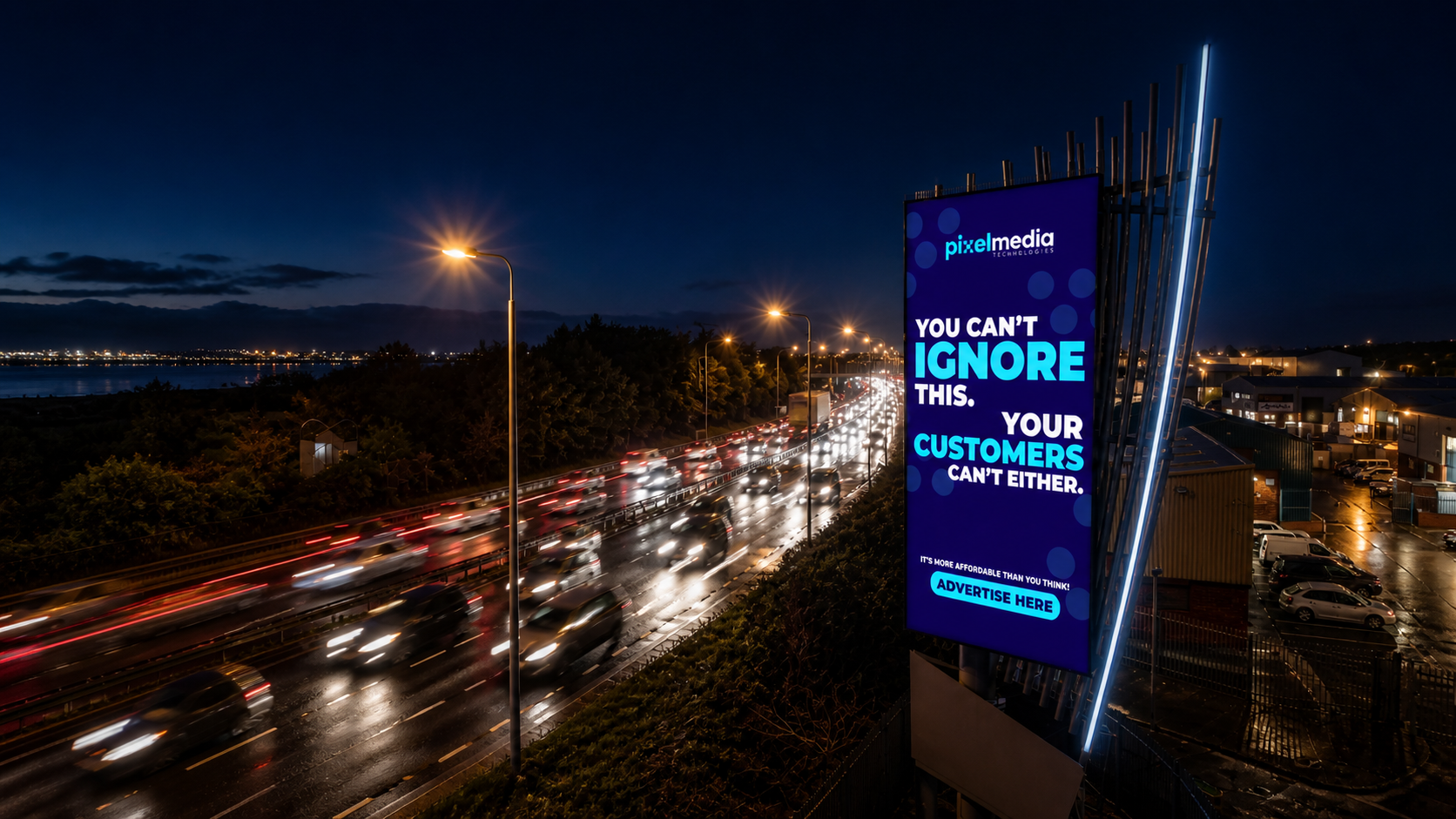 A large digital billboard on a city street at night, displaying an advertisement with blue and white text. The background features a busy highway with streaks of red and white car lights, streetlights illuminating the scene, and a dark sky with some clouds and distant city lights.