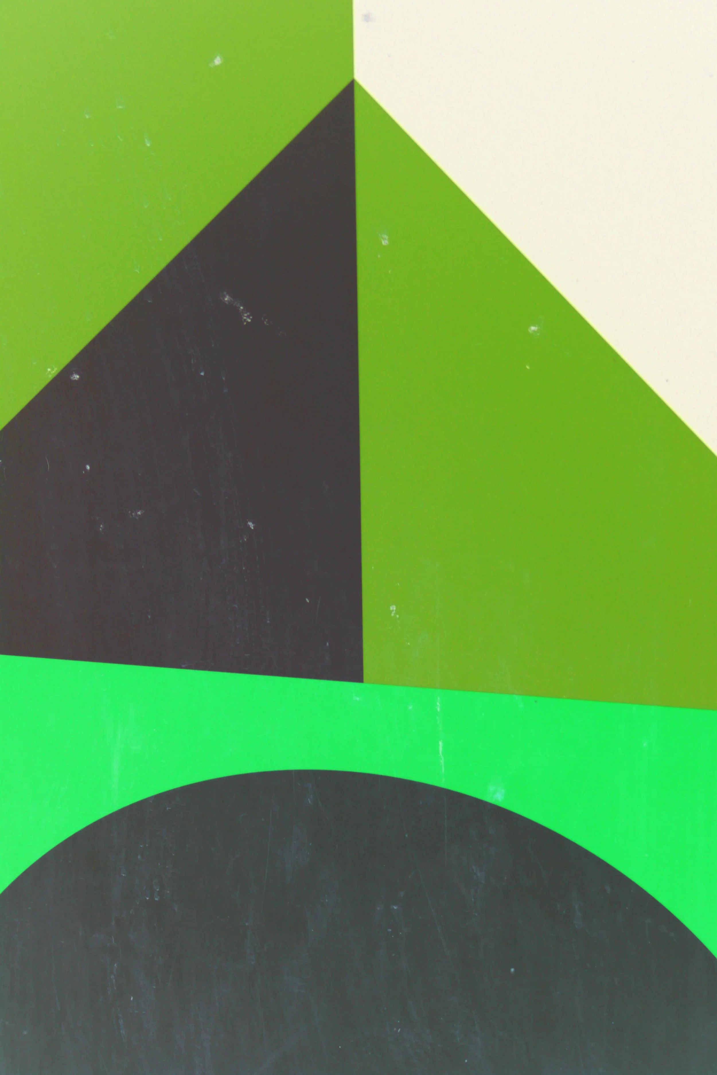 Close-up of geometric shapes in black, green, and white on a surface, possibly part of a modern art piece or abstract design.