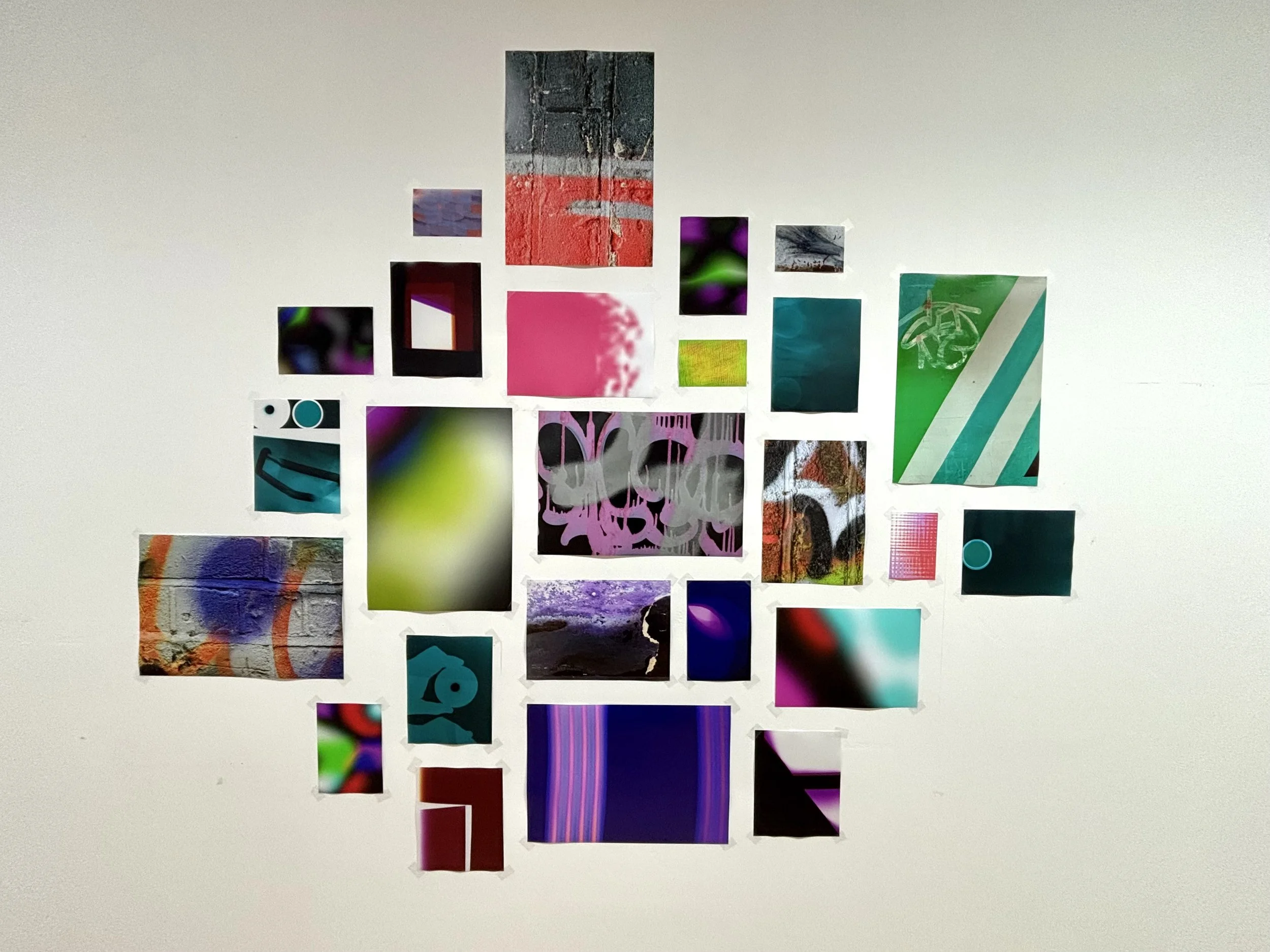 Collage of various abstract, colorful, and textured images arranged on a white wall.