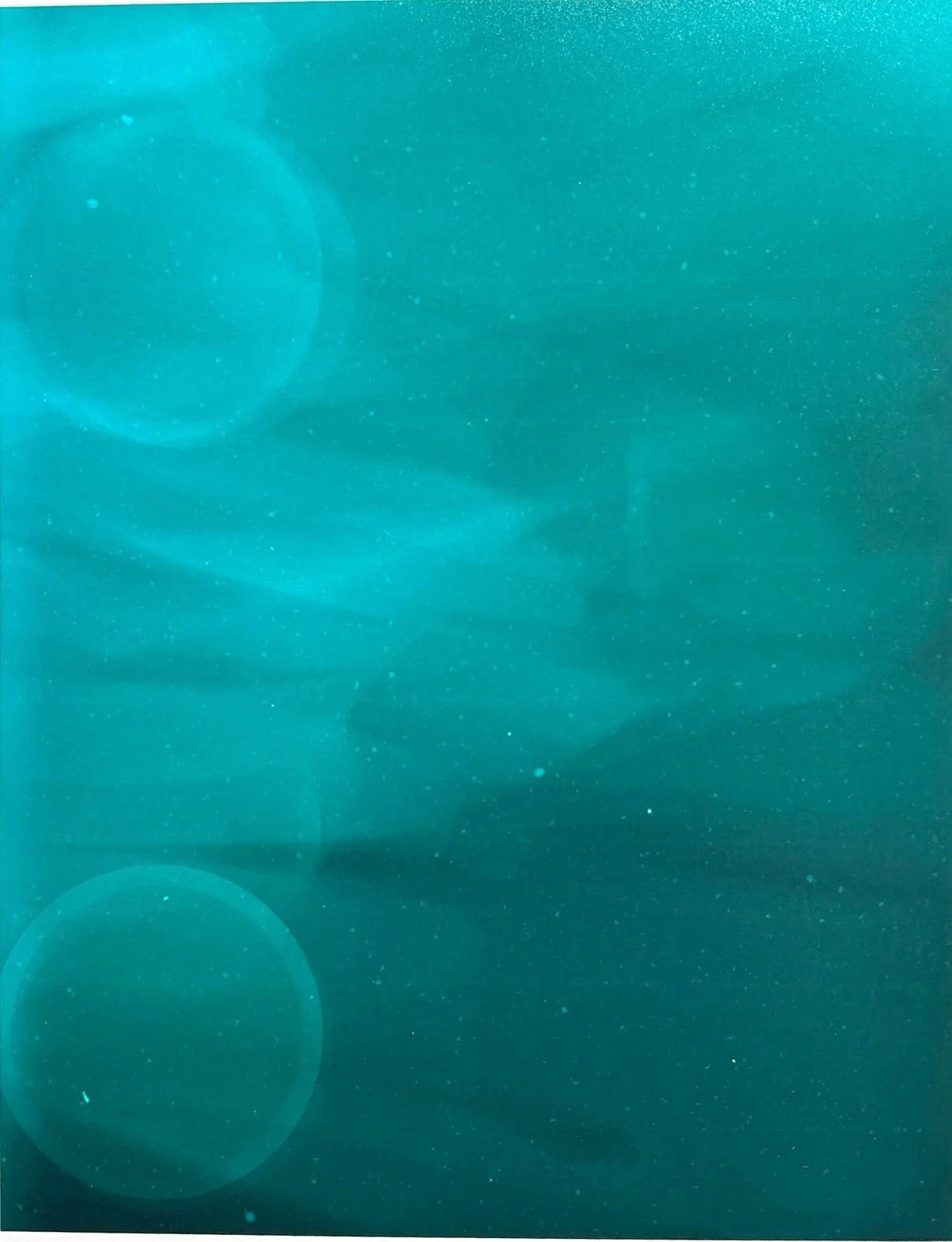 Abstract underwater scene with bubbles and light reflections in shades of blue and teal.