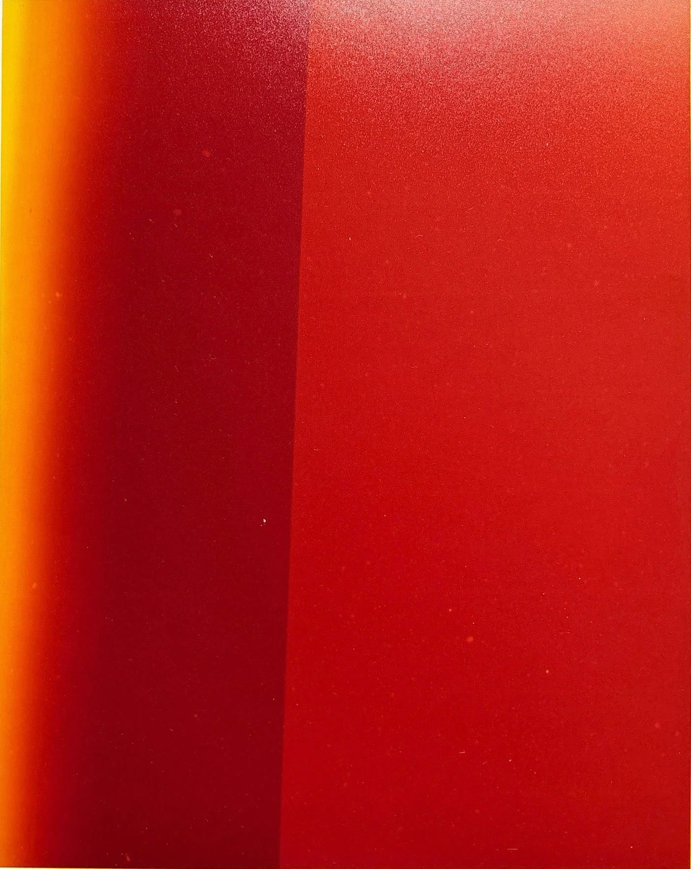 Close-up of a gradient background with shades of red, orange, and yellow. The colors blend smoothly from left to right.