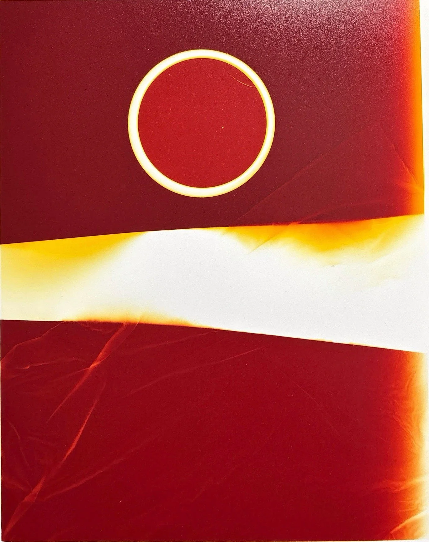 A circular neon light on a red background, with warm tones and abstract light streaks.