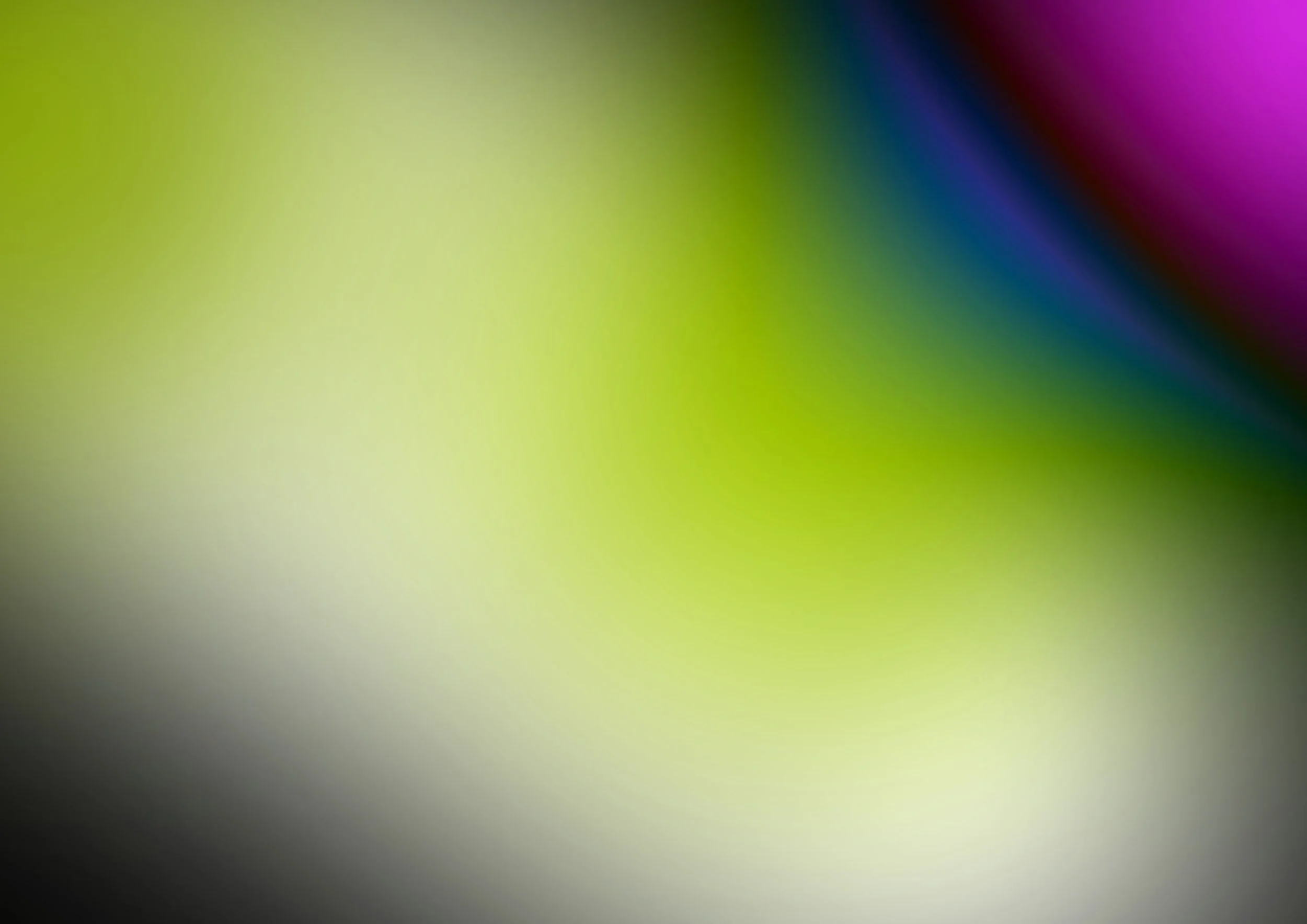 Blurred colorful abstract background with shades of green, purple, blue, yellow, and black.