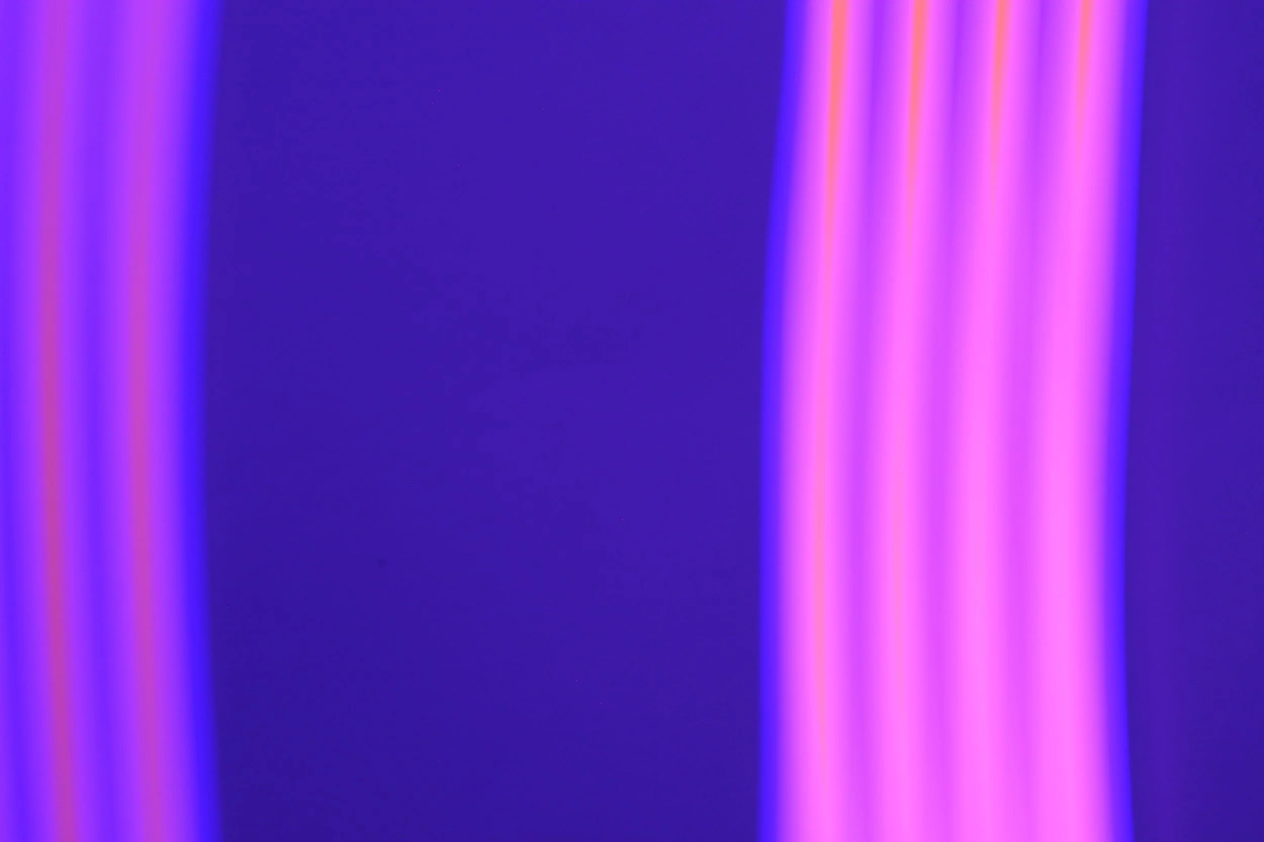 Abstract lights with pink, purple, and blue neon glow on a dark background.