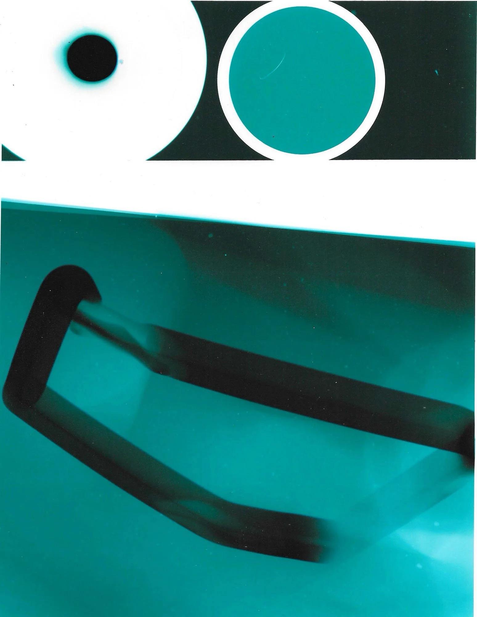 Close-up of a teal hard drive or electronic device with black and white design elements.