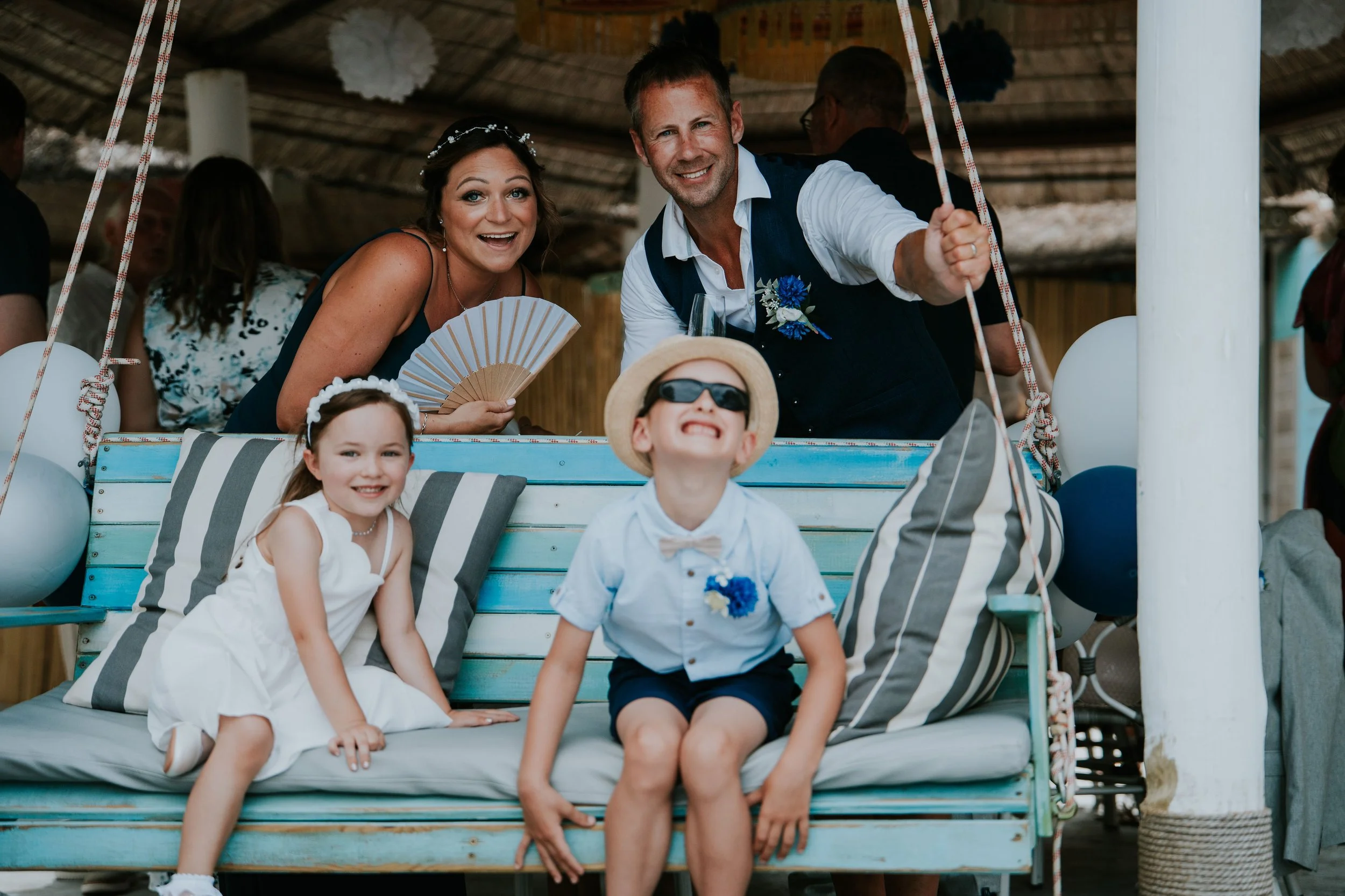 Relaxed Ibiza-style wedding at L’Andragó, Moraira with flower girl and ring bearer on a garden swing