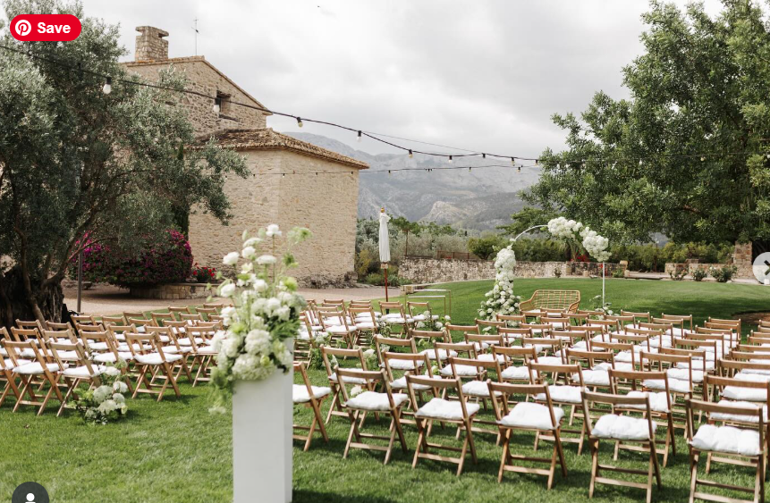 Luxury villa wedding ceremony setup at Casa Benegalip near Moraira with white flowers and a romantic floral arch