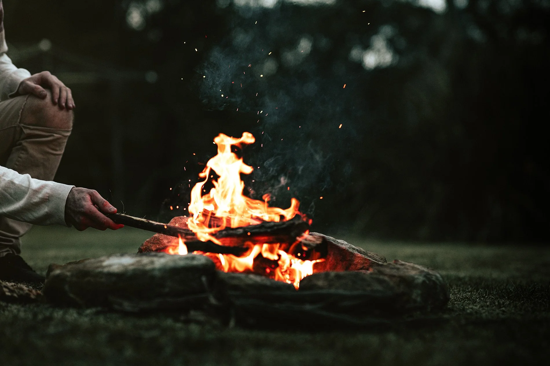 Man stoking the fire at Blackwood Valley retreat
