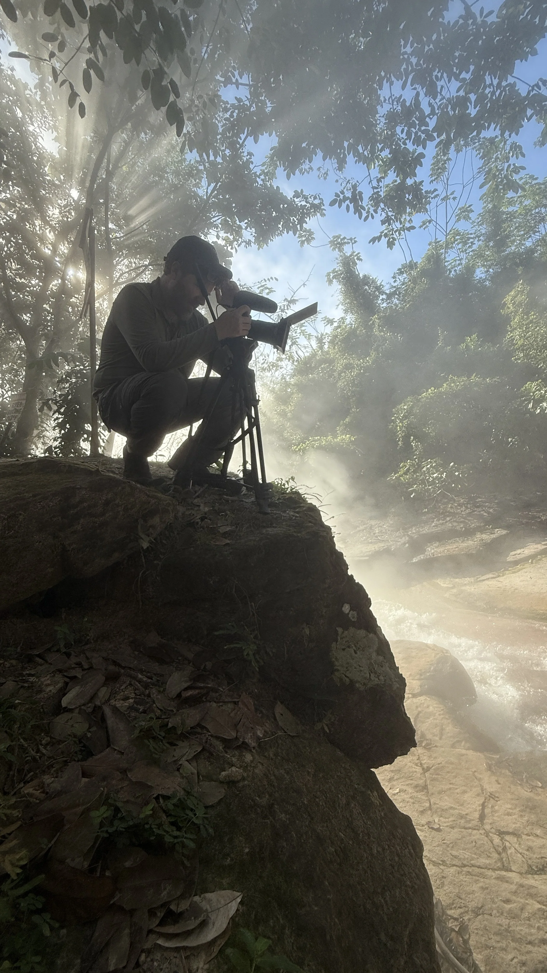 Brian Emery filming at the Boiling River, Peru