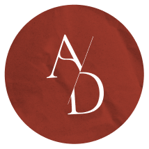 A red crumpled paper background with white stylized initials 'A' and 'D' arranged diagonally.