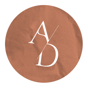 Brown paper bag with white stylized initials A and D
