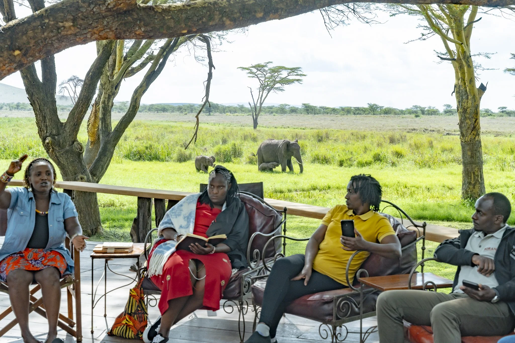 A plenary session at Sirikoi Lodge with members discussing sustainability anchored on The Long Run ethos of the 4Cs with a herd of elephants in the background.