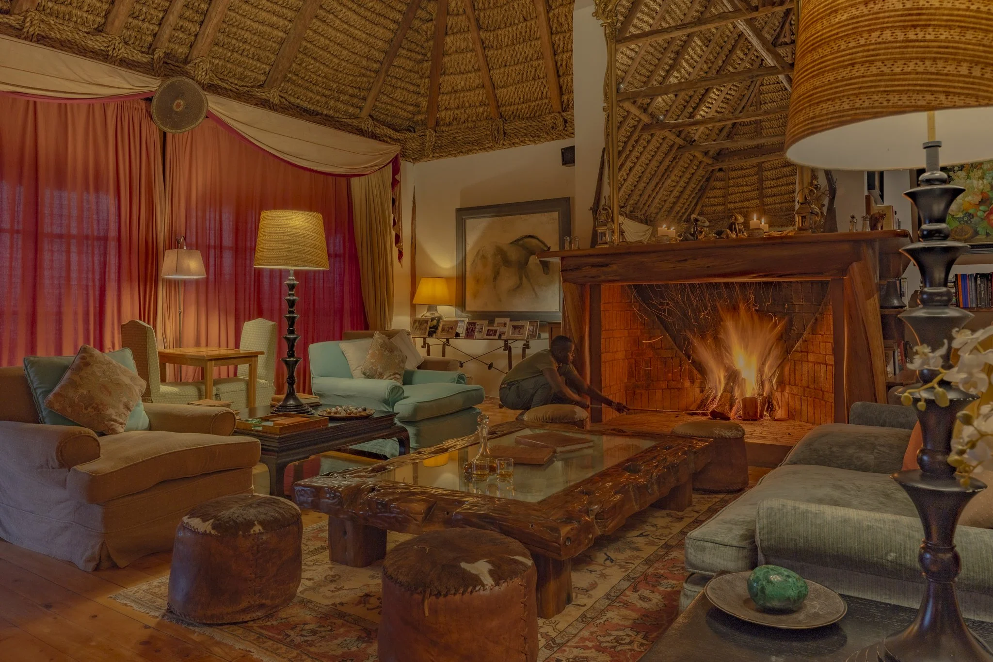 Cozy drawing room in the evening with a big fire at the fireplace