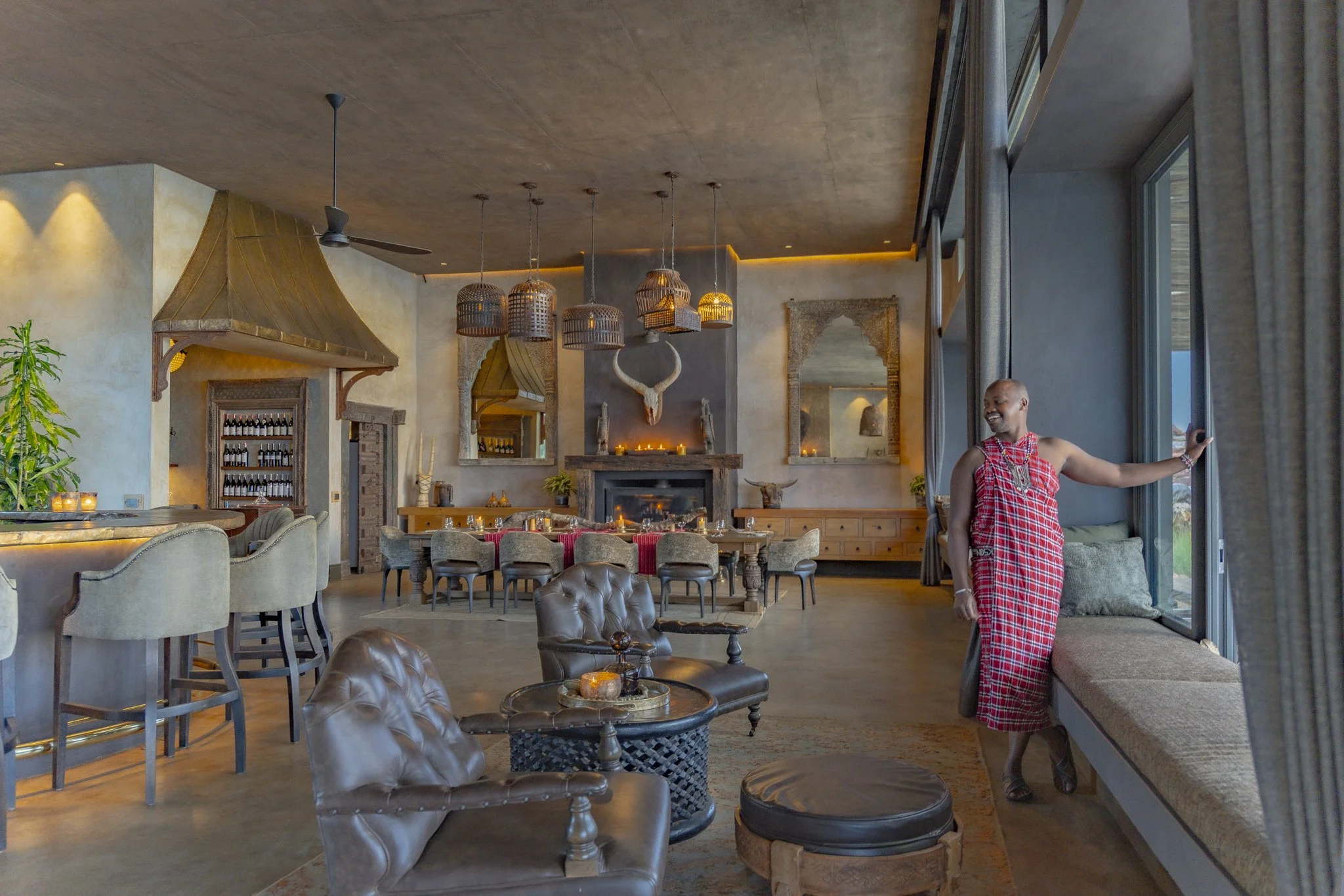 Maasai Moran adorned in traditional wear at Wild Hill's dining setup
