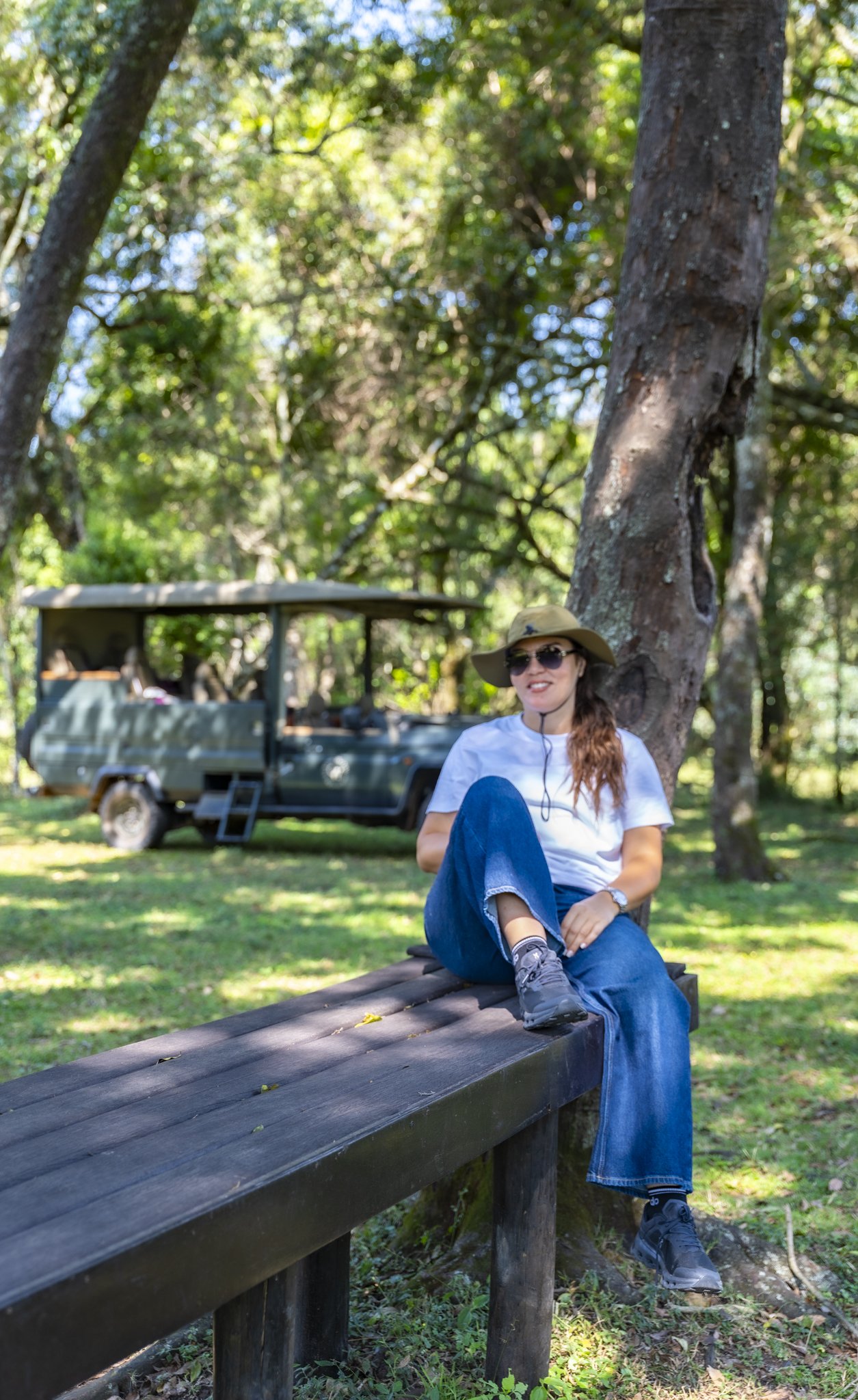 Guest at a picnic area with safari vehicle in the background