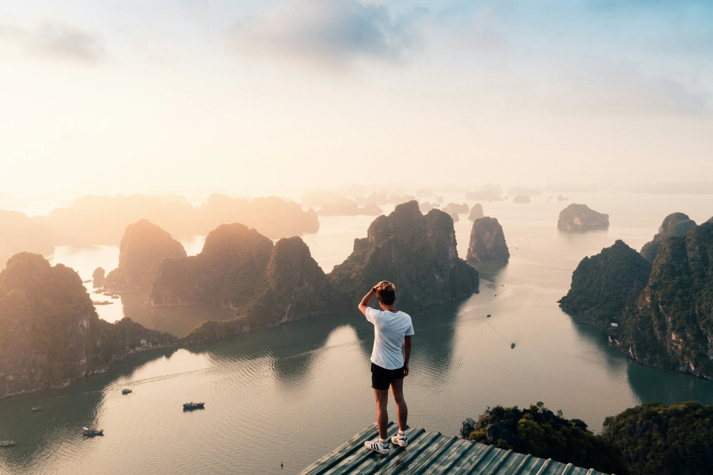 Traveler on mountain representing flawless execution and access to exclusive experiences