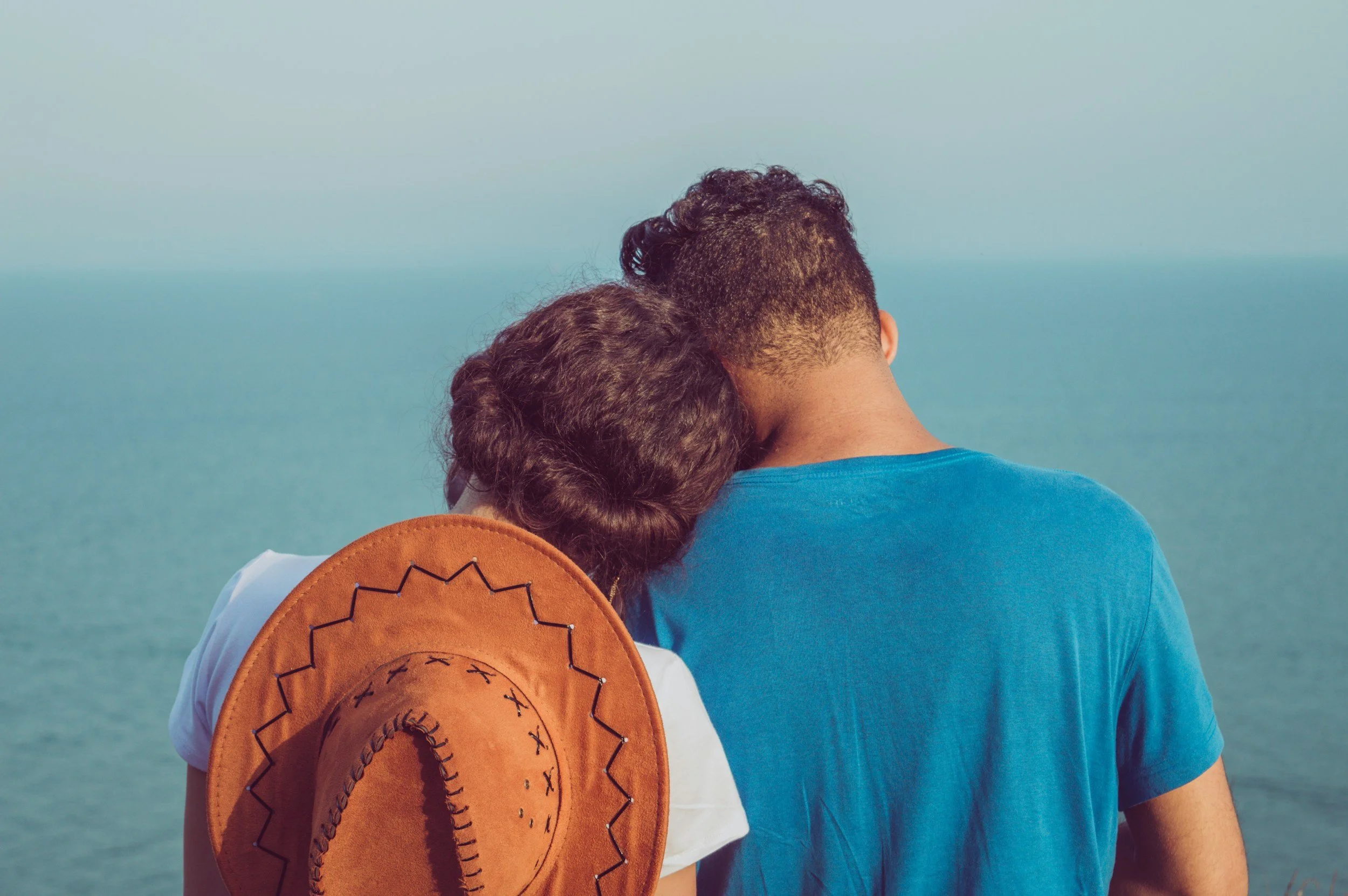 Couple enjoying intimate moment on beach representing milestone celebrations and honeymoons