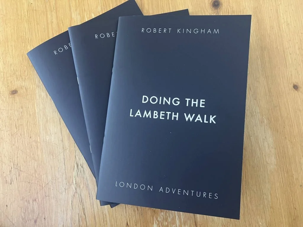Four copies of a book titled "Doing the Lambeth Walk: London Adventures" by Robert Kingham, arranged on a wooden surface.