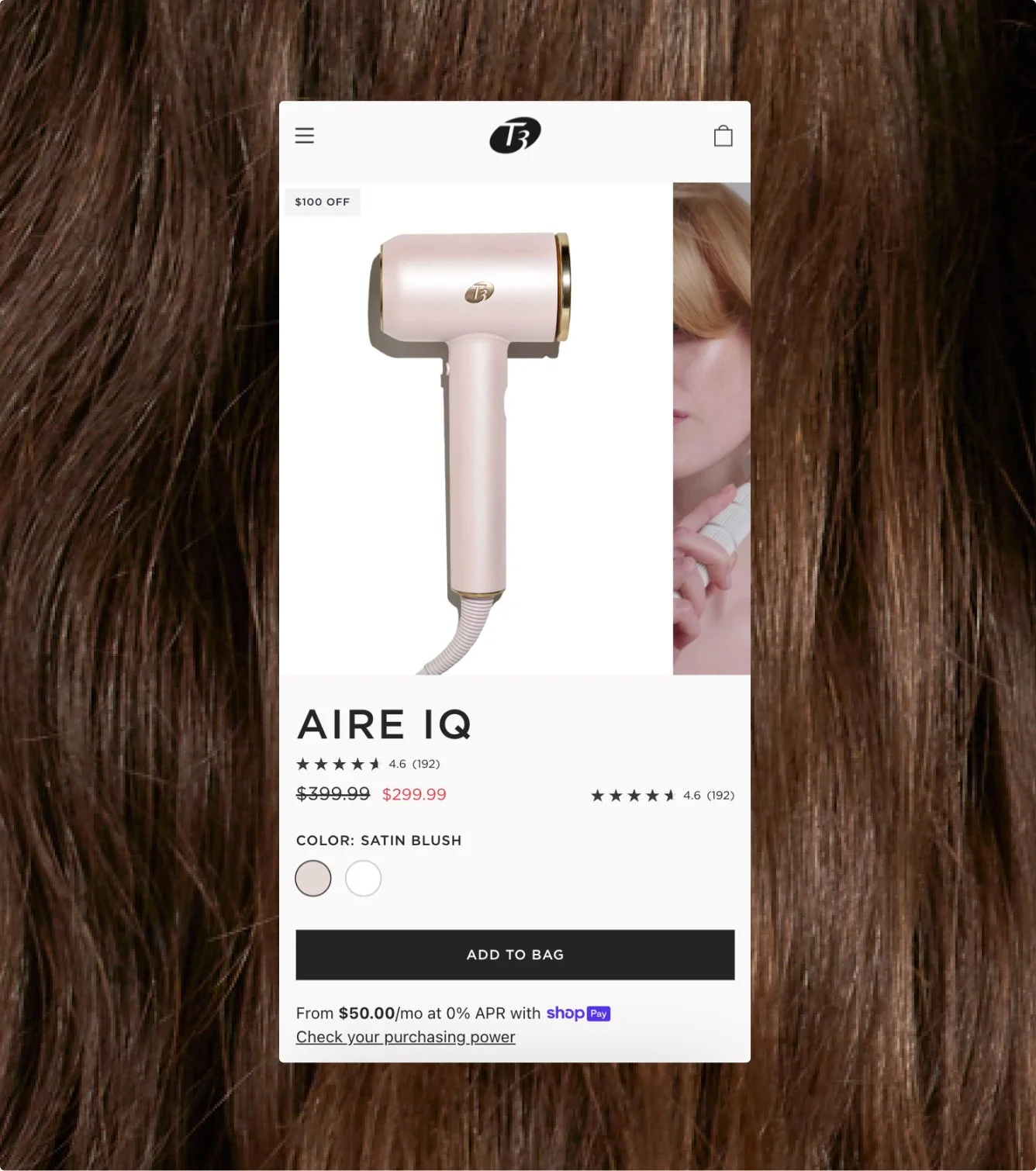 A smartphone displaying an online shopping page for a hair dryer, with a background of brown hair.