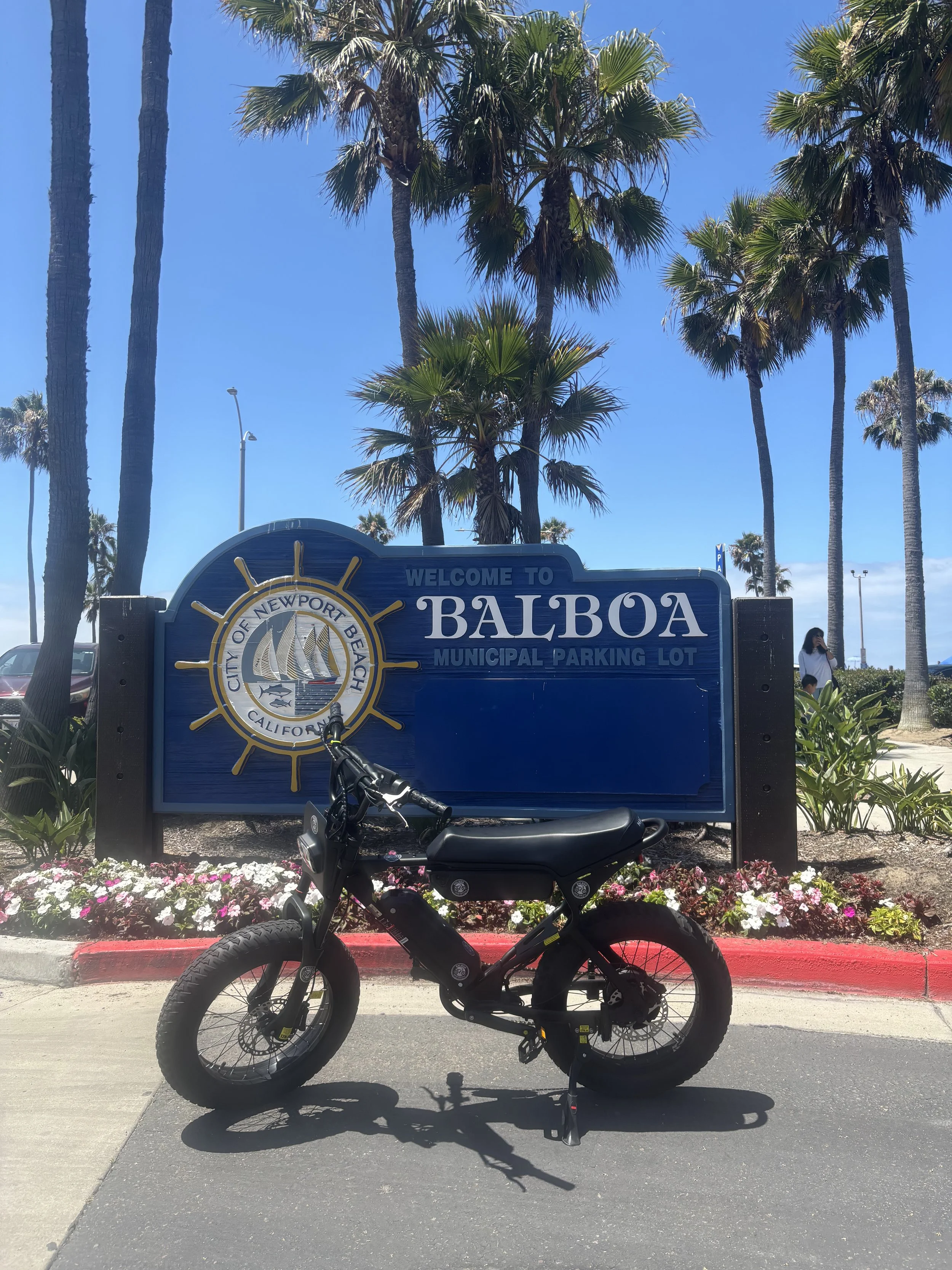 Macfox electric bike at the Welcome to Balboa sign on the Balboa Peninsula in Newport Beach, California.