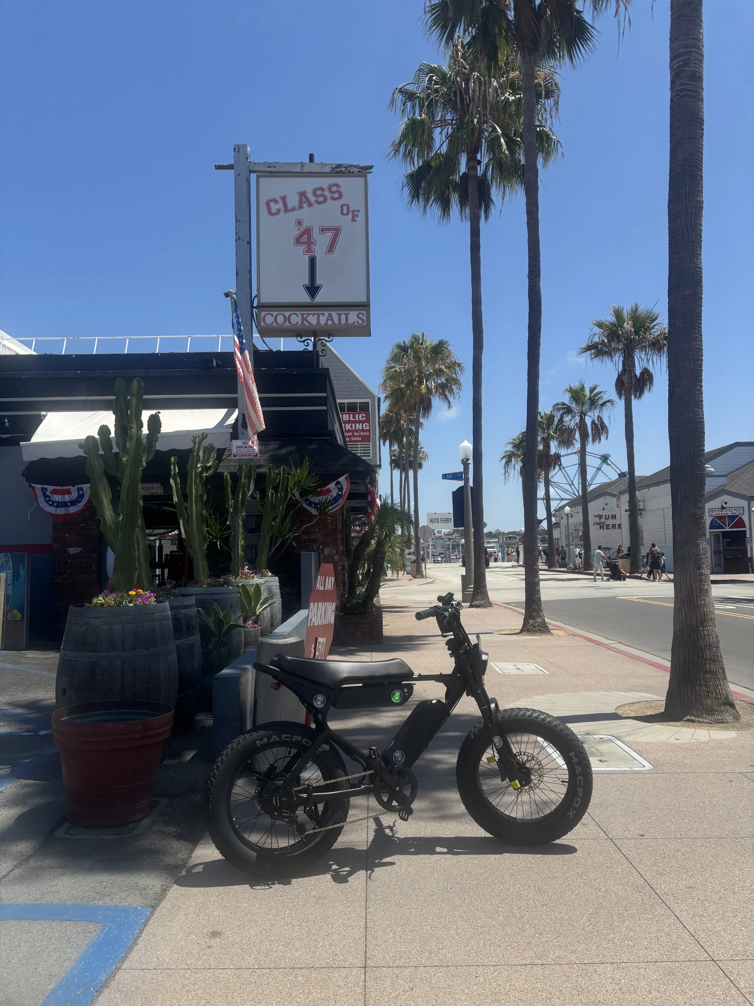 Macfox electric bike parked outside local businesses on the Balboa Peninsula in Newport Beach, California.