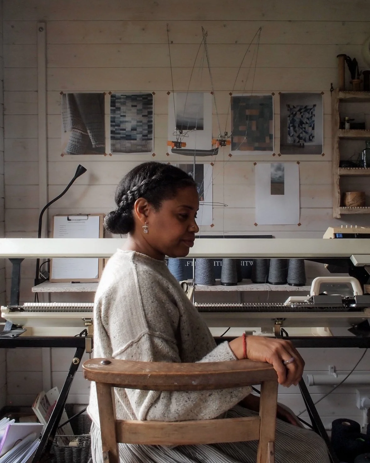 Jules sat in her studio by her knitting machine