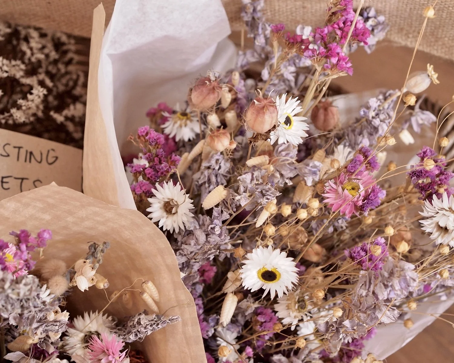 Bouquet's of dried flowers and grasses, warm neutrals, pinks and soft lilac.