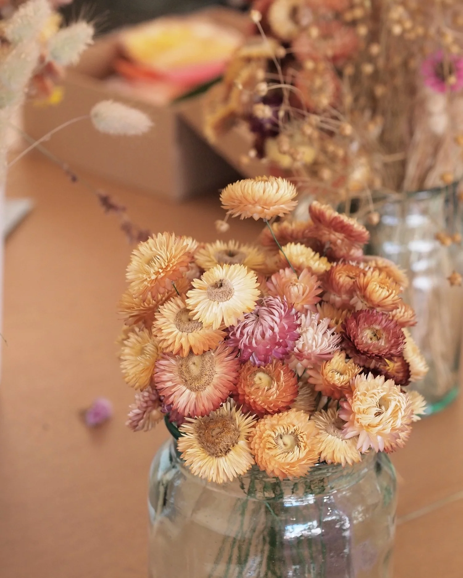 Home grown straw flowers in jam jars.