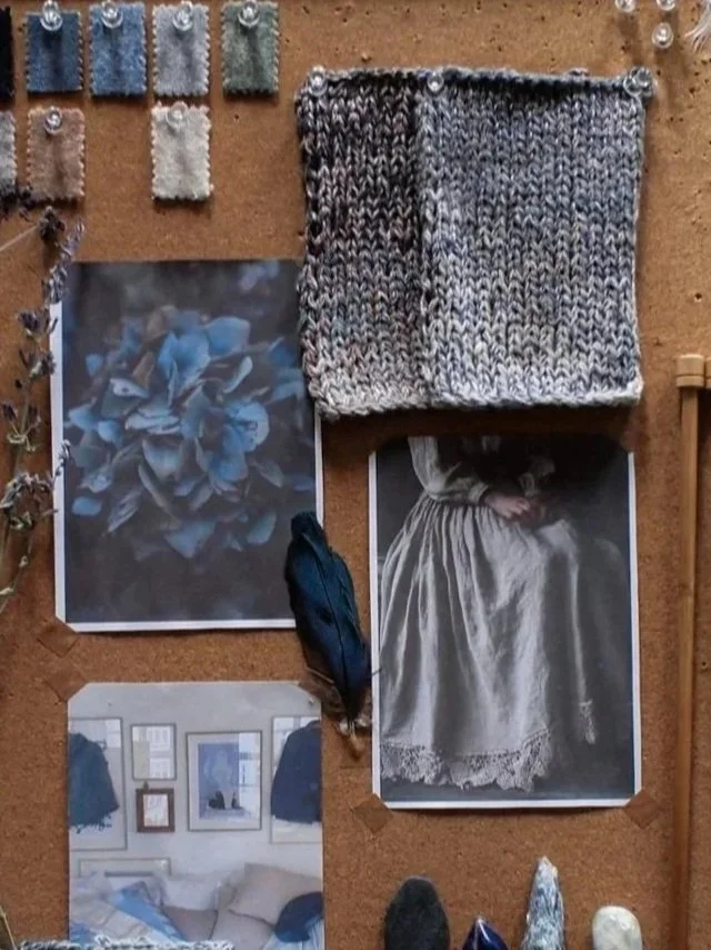A bulletin board with yarn, photographs, and fabric swatches pinned to it.