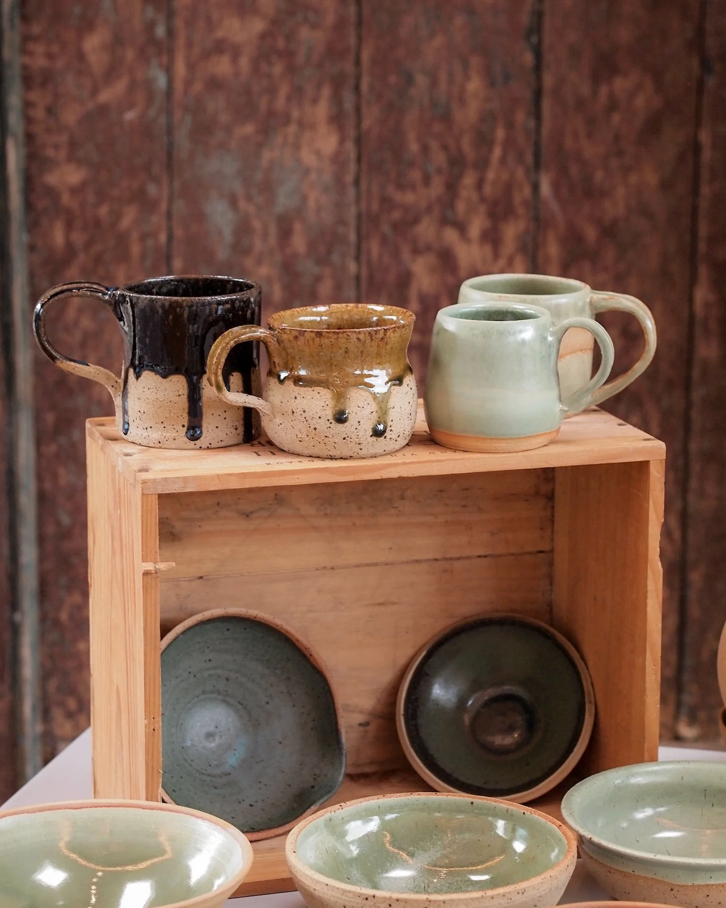 mugs and bowls by lisa dukes. celadon, smoke grey and ochre. drip glaze effect on the mugs