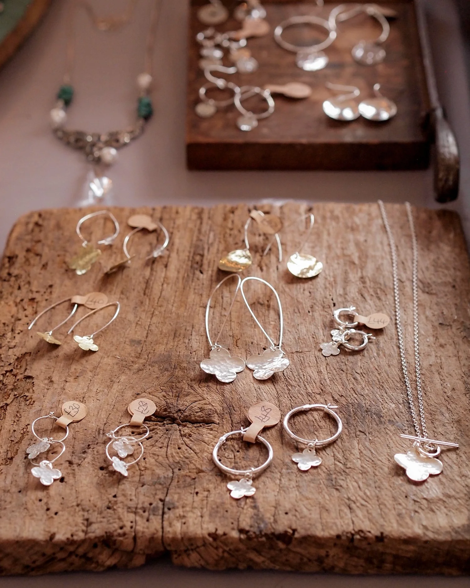 silver jewellery by elaine fraser king. earrings with floral detail.