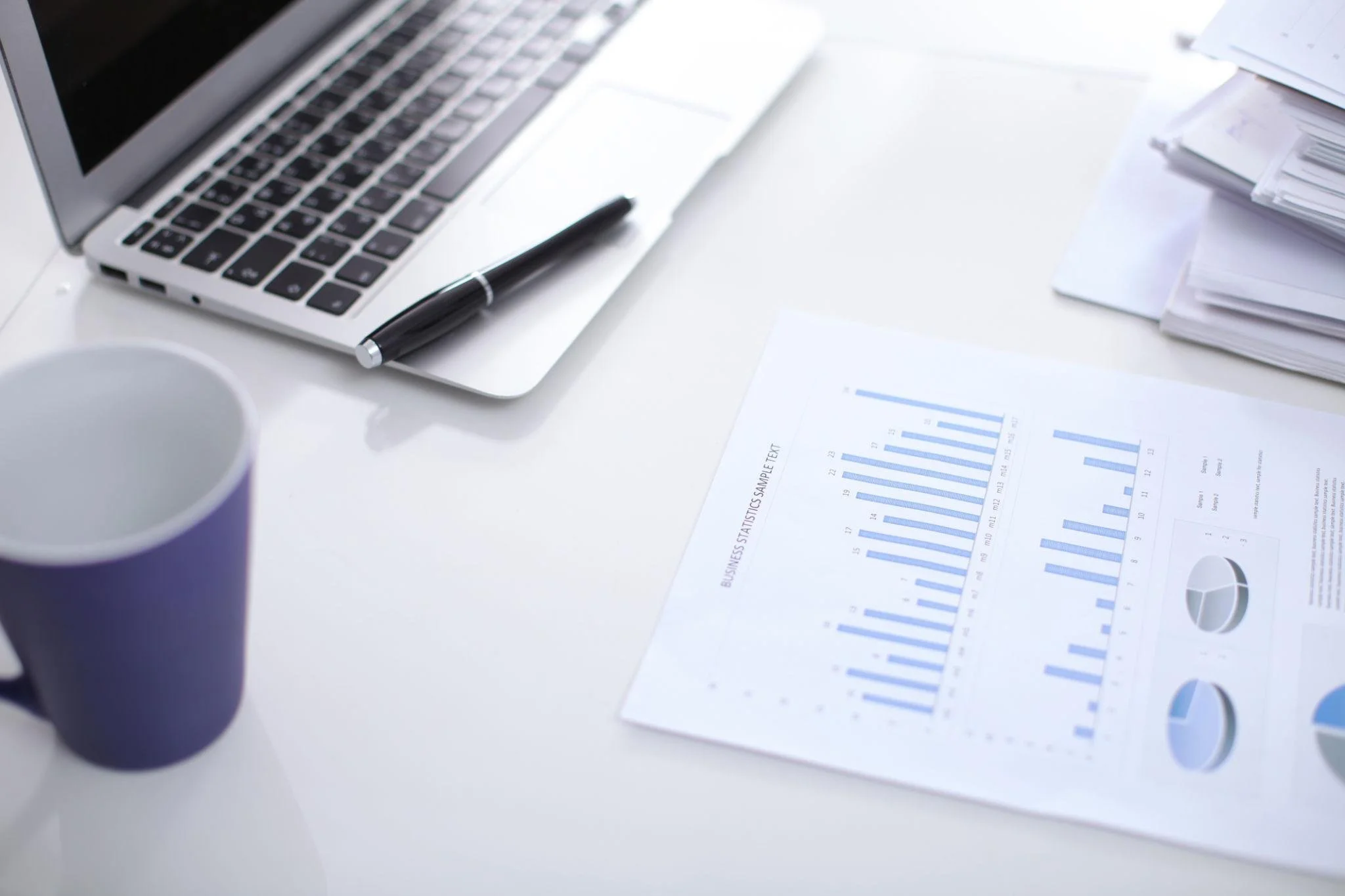 Financial data analysis and portfolio construction documents on a desk for wealth management consulting.