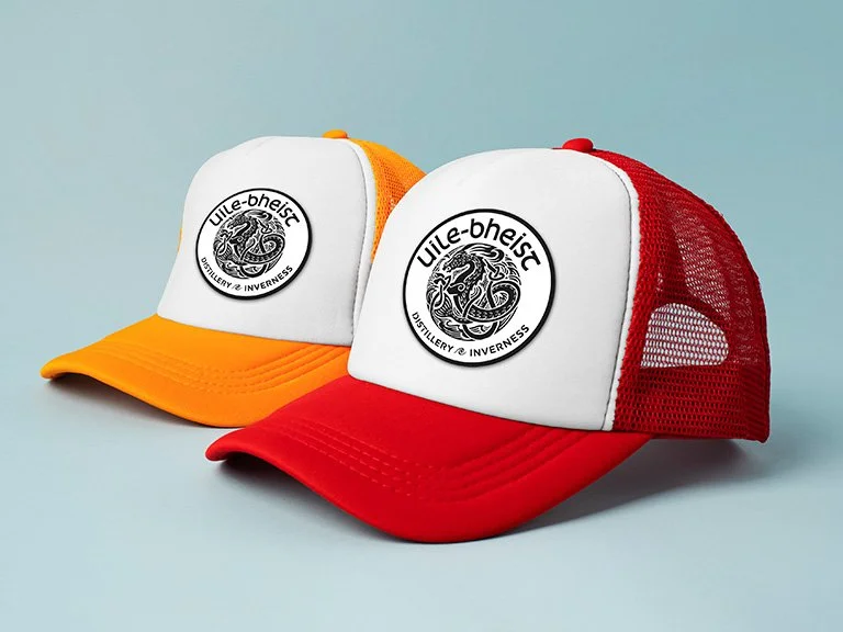 Uile-bheist tricker caps in red and orange, with white front panel. Featuring embroidered distillery badge.