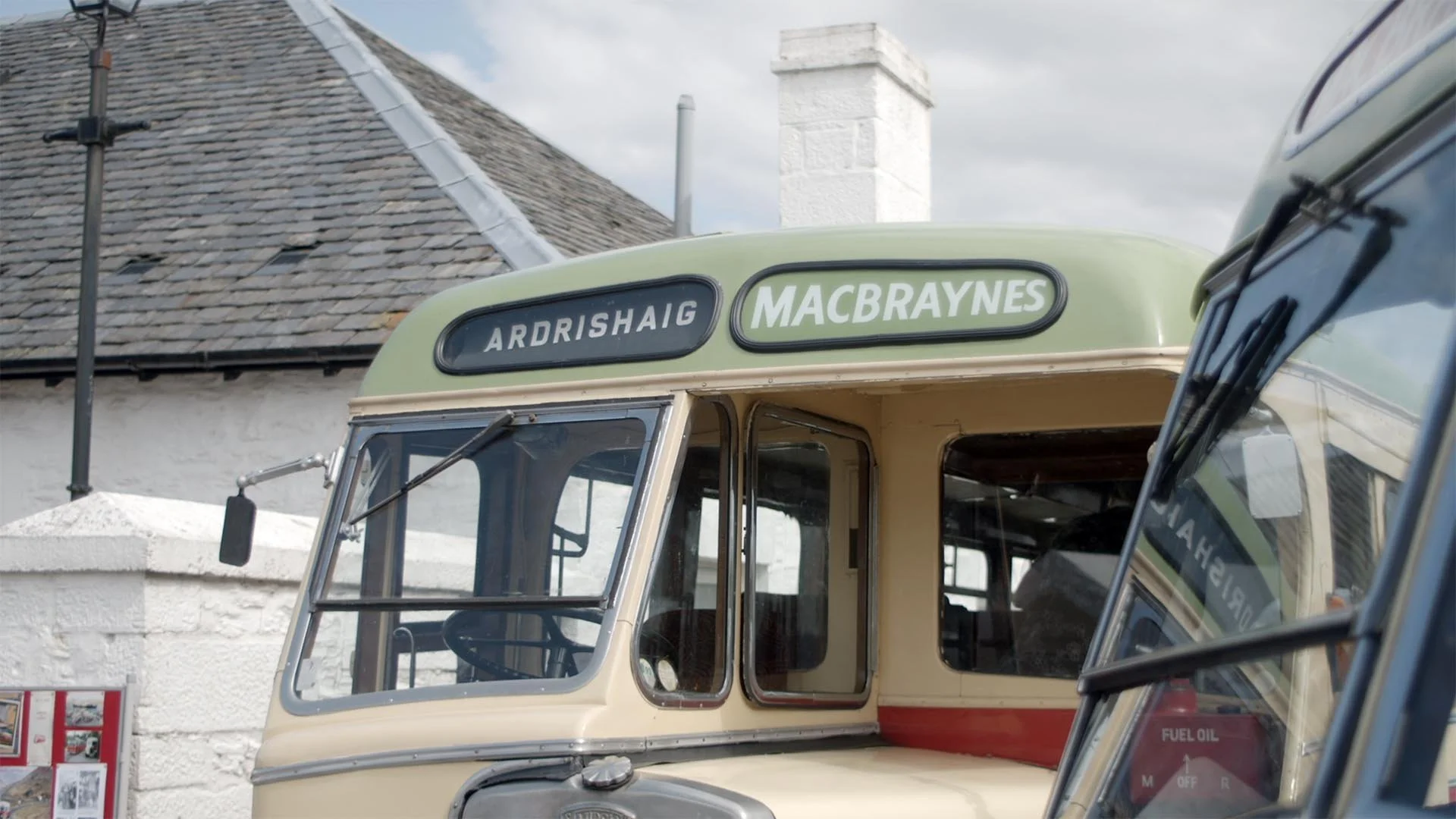 Close-up of a vintage MacBraynes bus with a destination sign reading "Ardrishaig" parked at the Steamer Terminal.