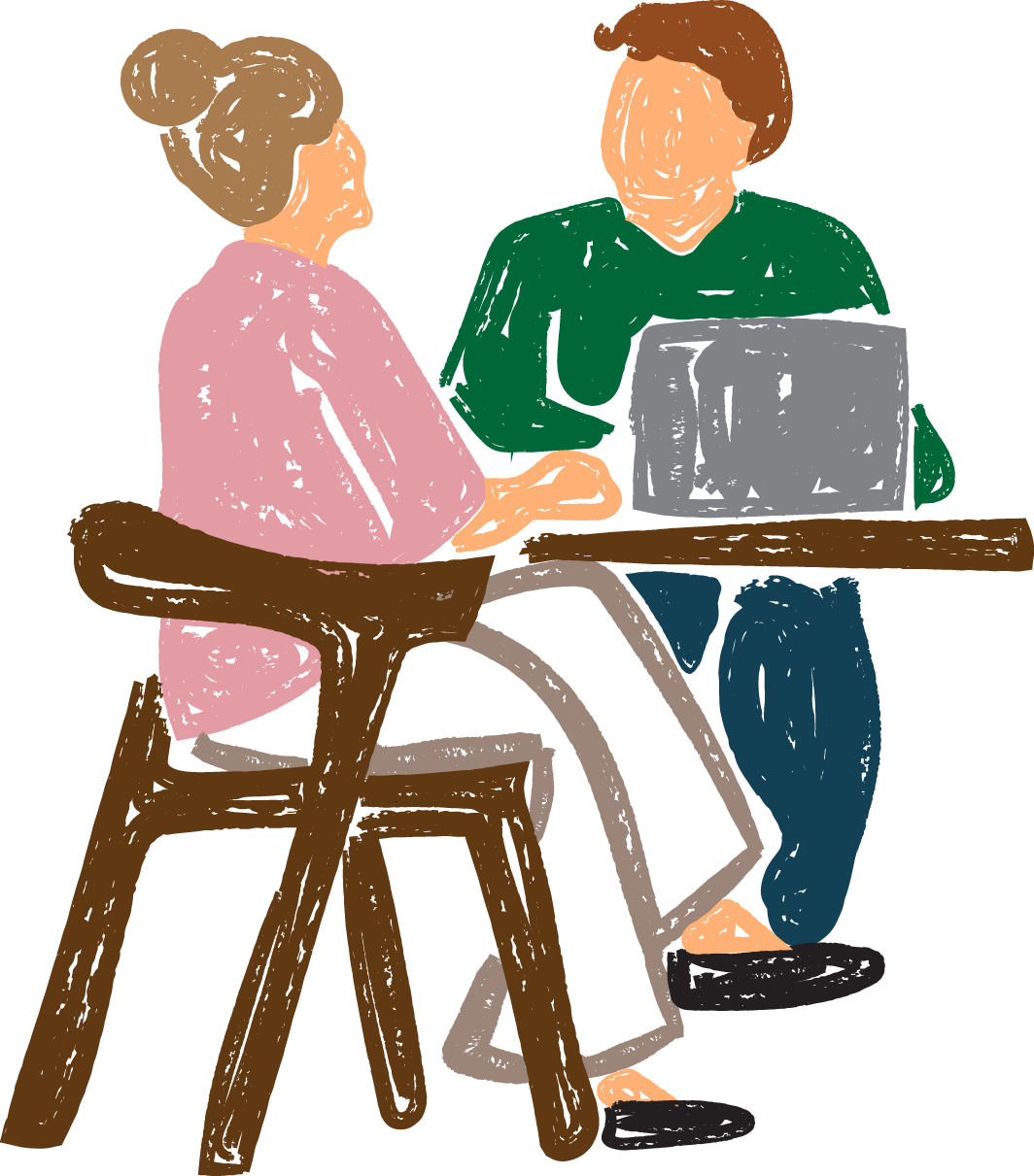 Two people sitting at a table, a man is working on laptop while listening to a woman speak.