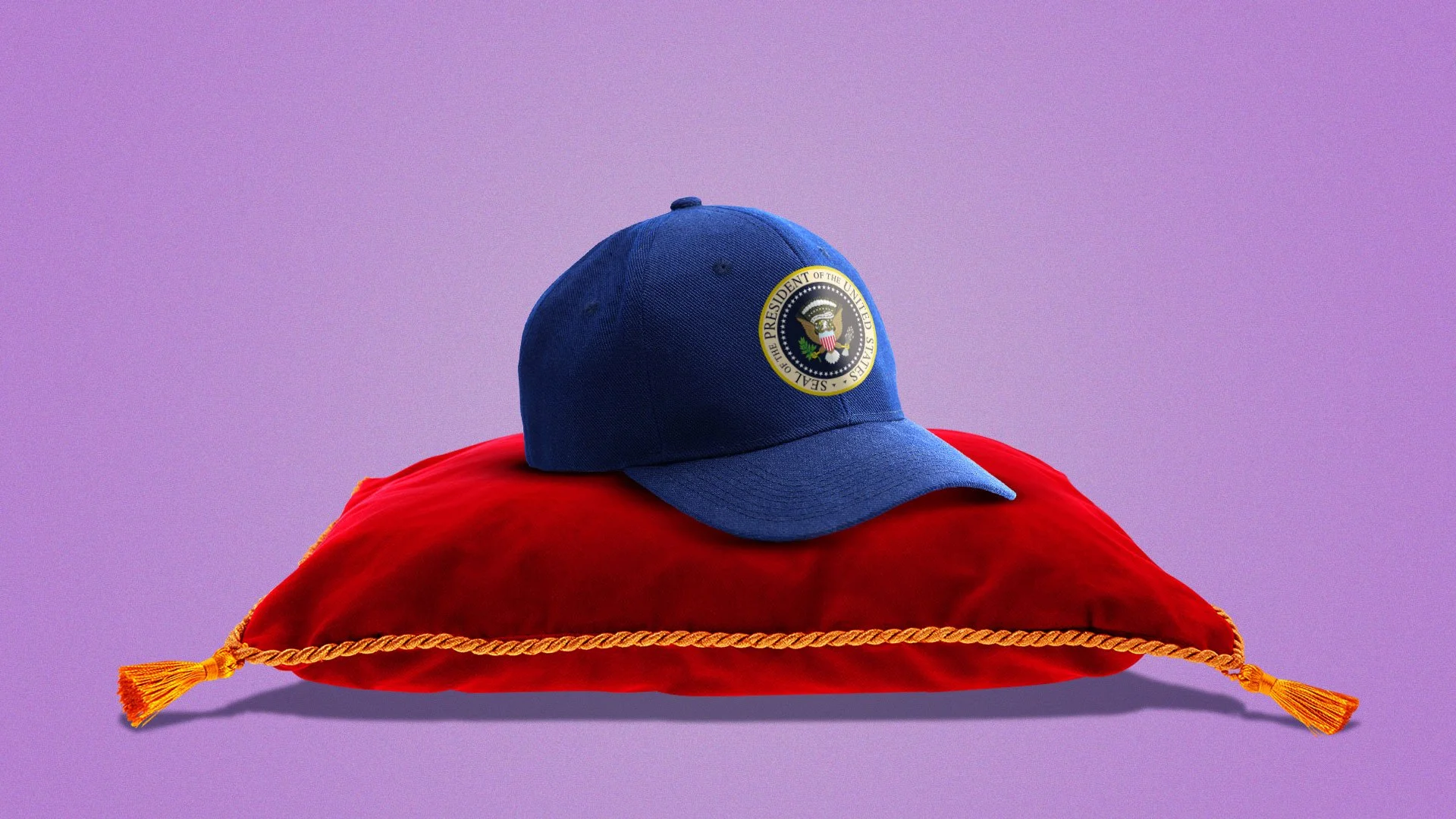 A blue baseball cap with the seal of the President of the United States, placed on a red velvet pillow with gold trim and tassels, against a purple background.